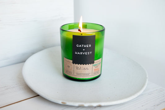 Beeswax candle, in green glass
