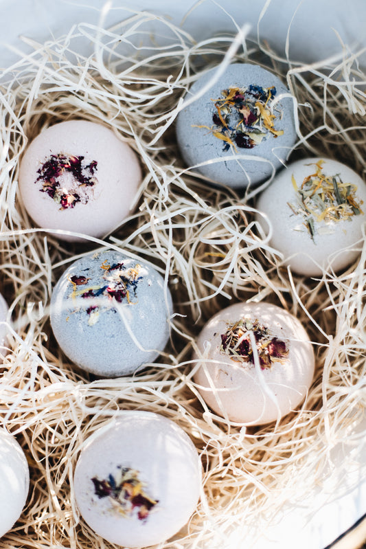 Bath Bombs sitting in a bowl of straw